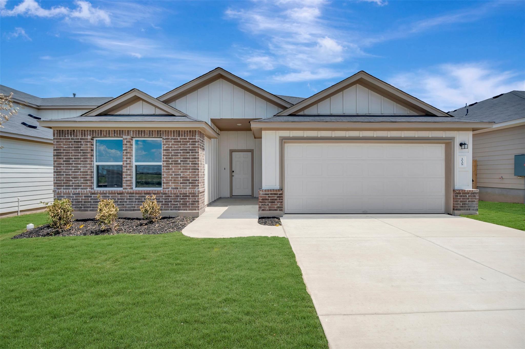 A neatly manicured lawn complements the charming 
