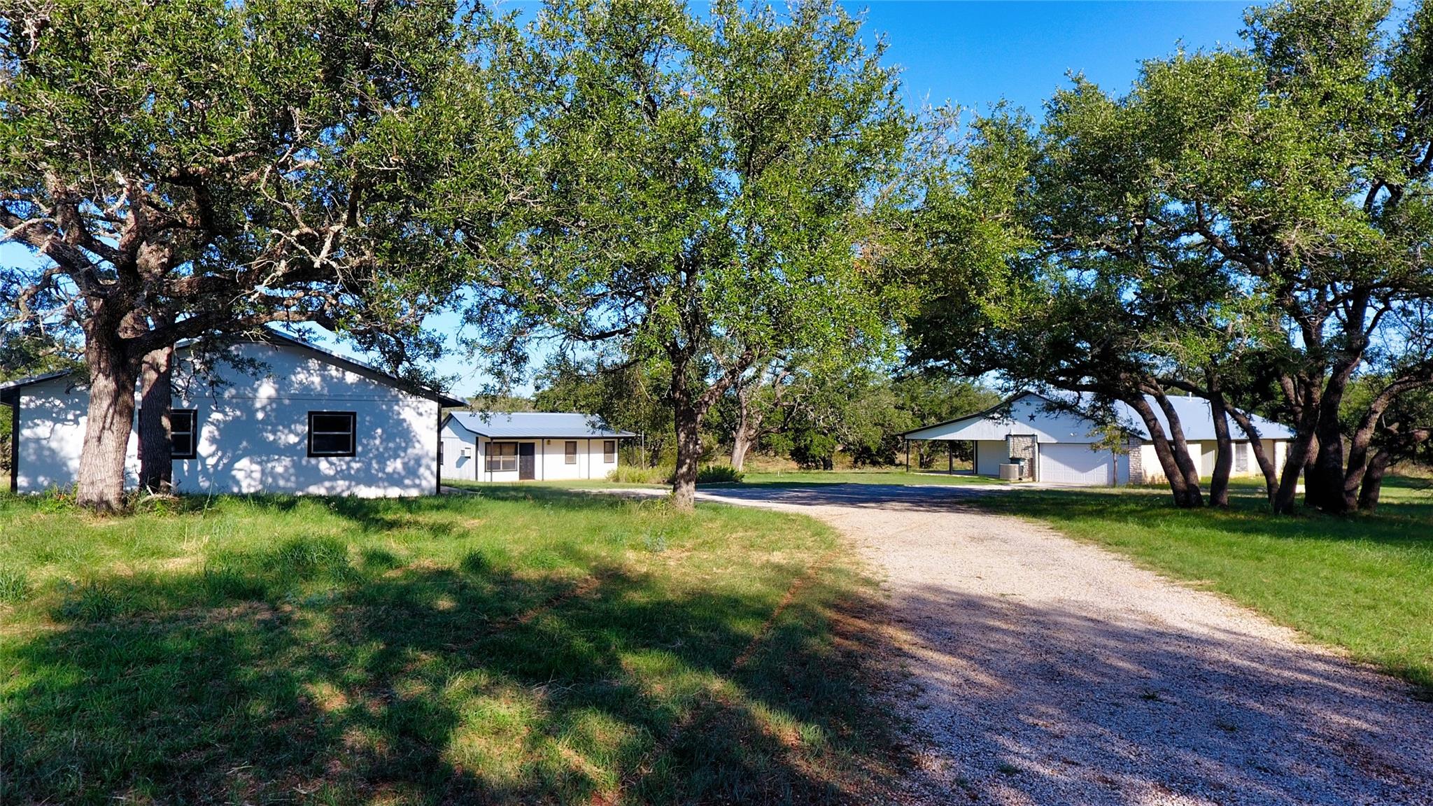 A private gravel driveway leads to serene homes s