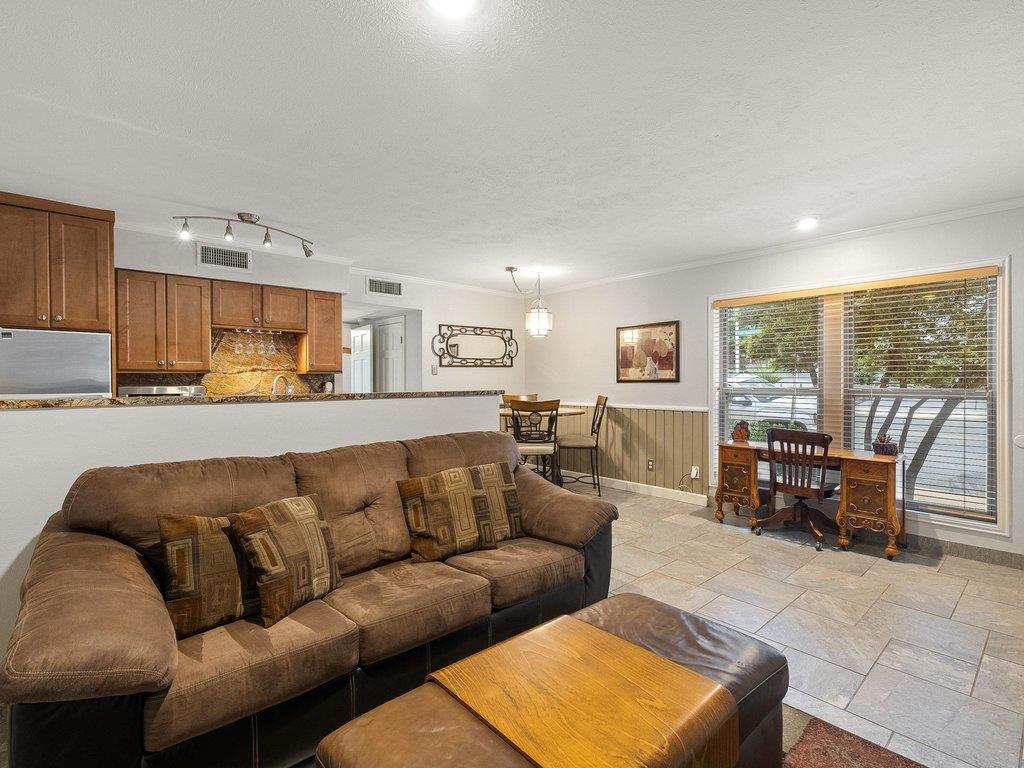 Tiled flooring and large windows enhance this ope