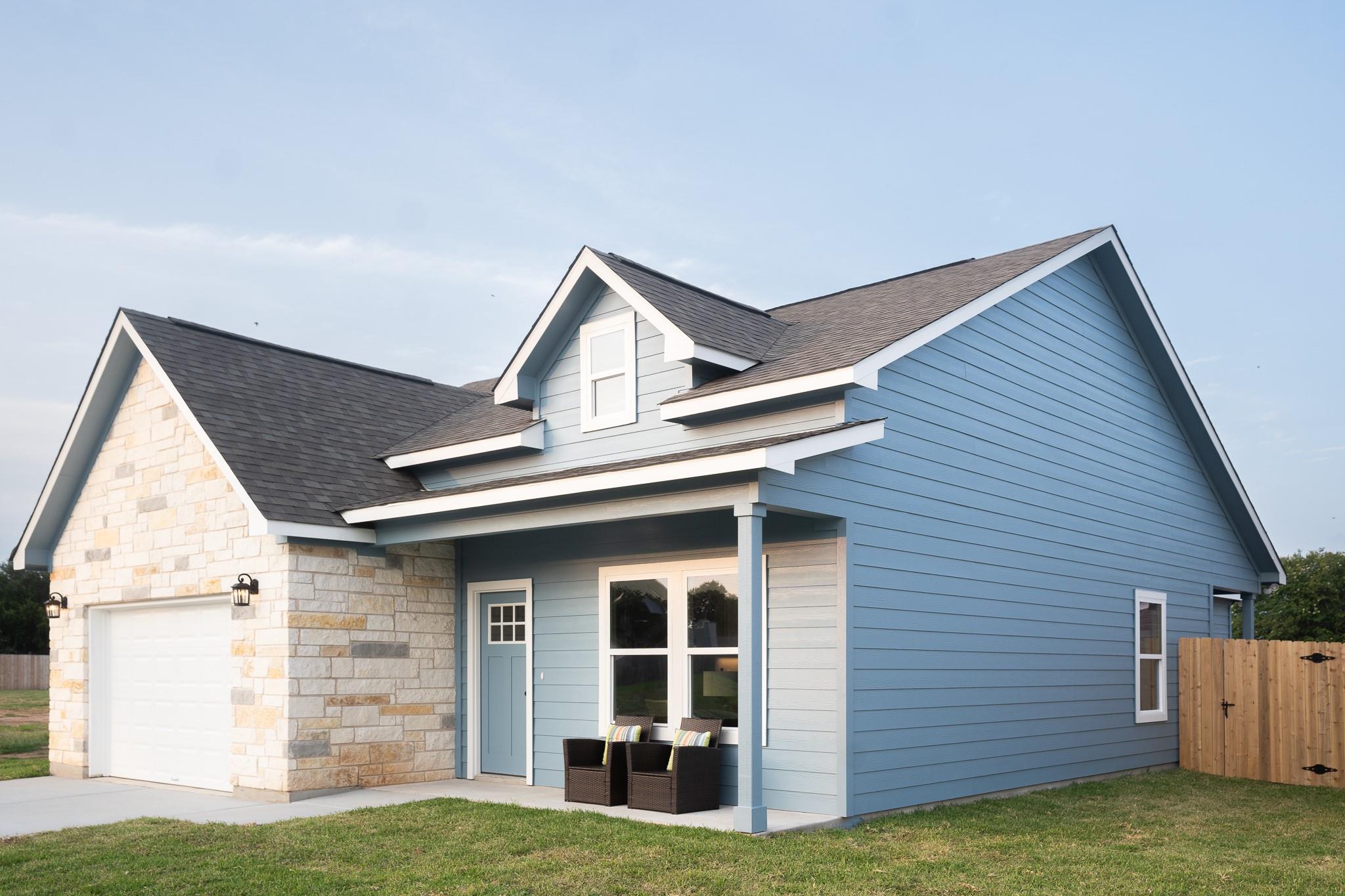 View of front of property with a shingled roof, a