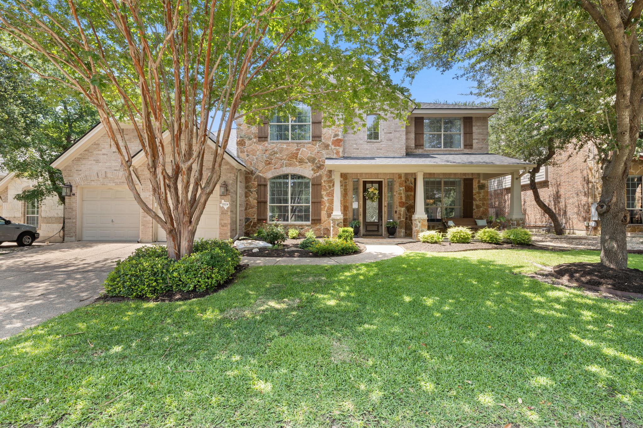 A welcoming stone and brick facade with a covered