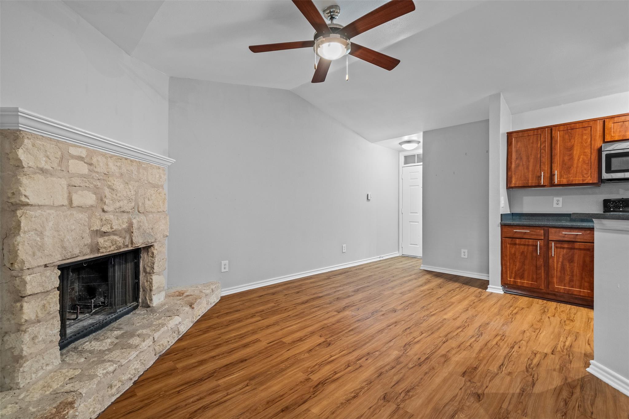 Living area featuring a stone fireplace with a wh