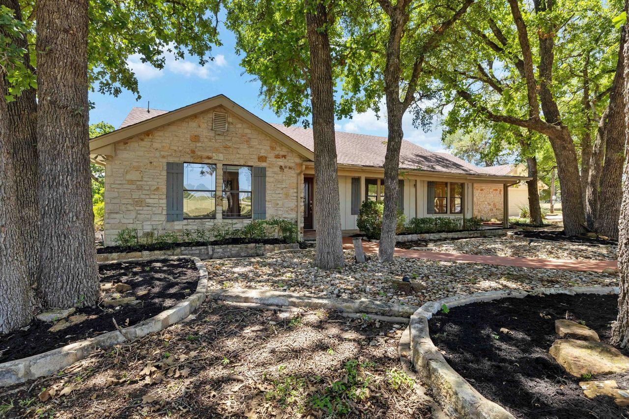 Mature trees shade this charming residence with s