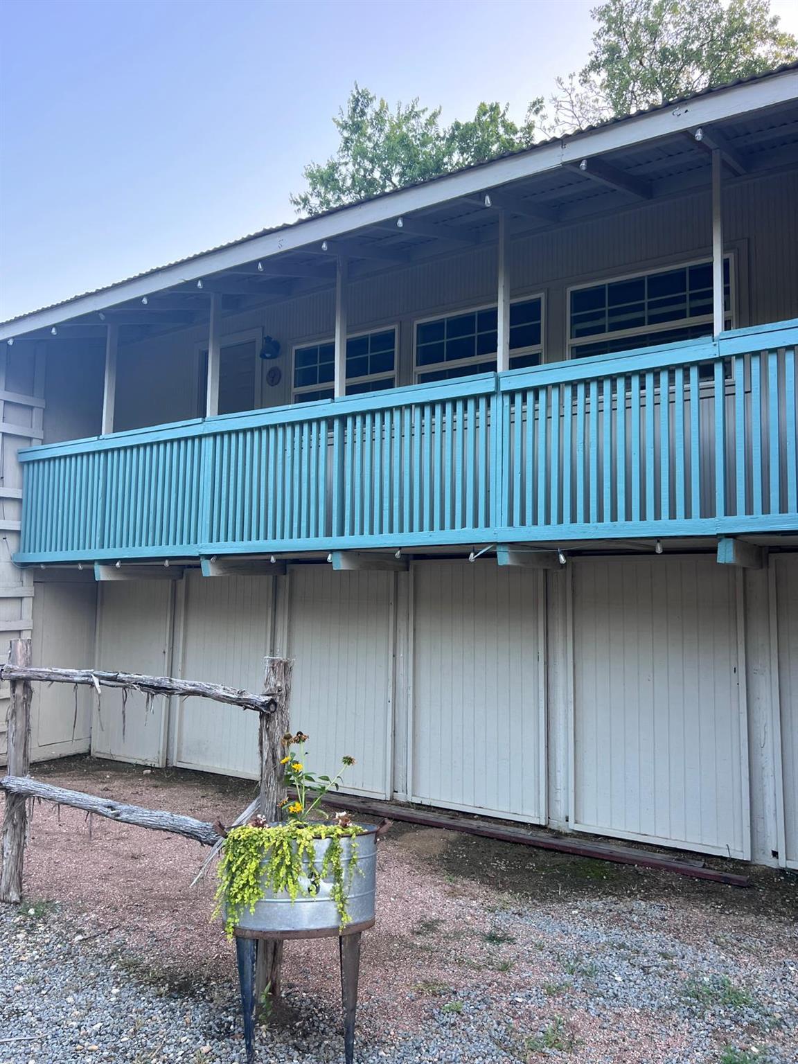 A charming exterior with a vibrant blue balcony o