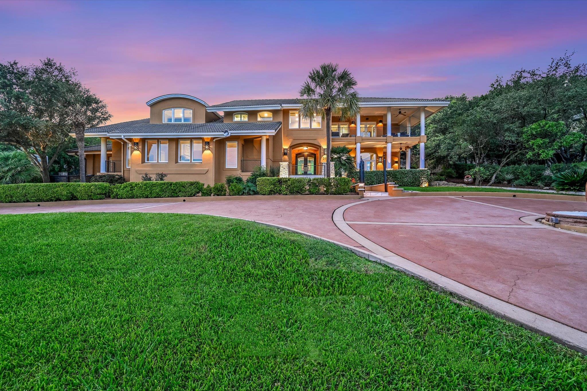 A grand estate awaits, featuring a circular drive