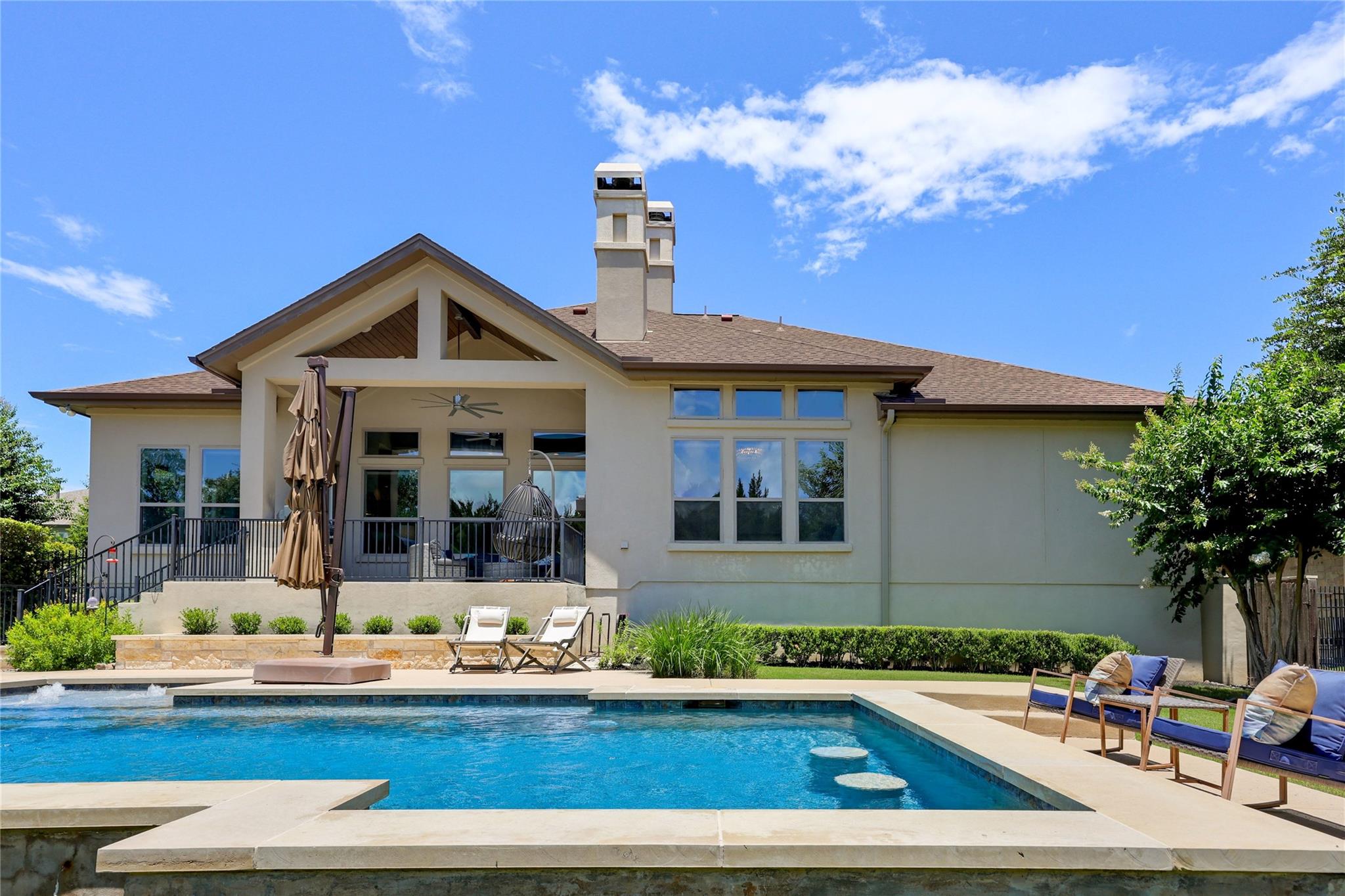 An inviting backyard oasis offers a sparkling poo