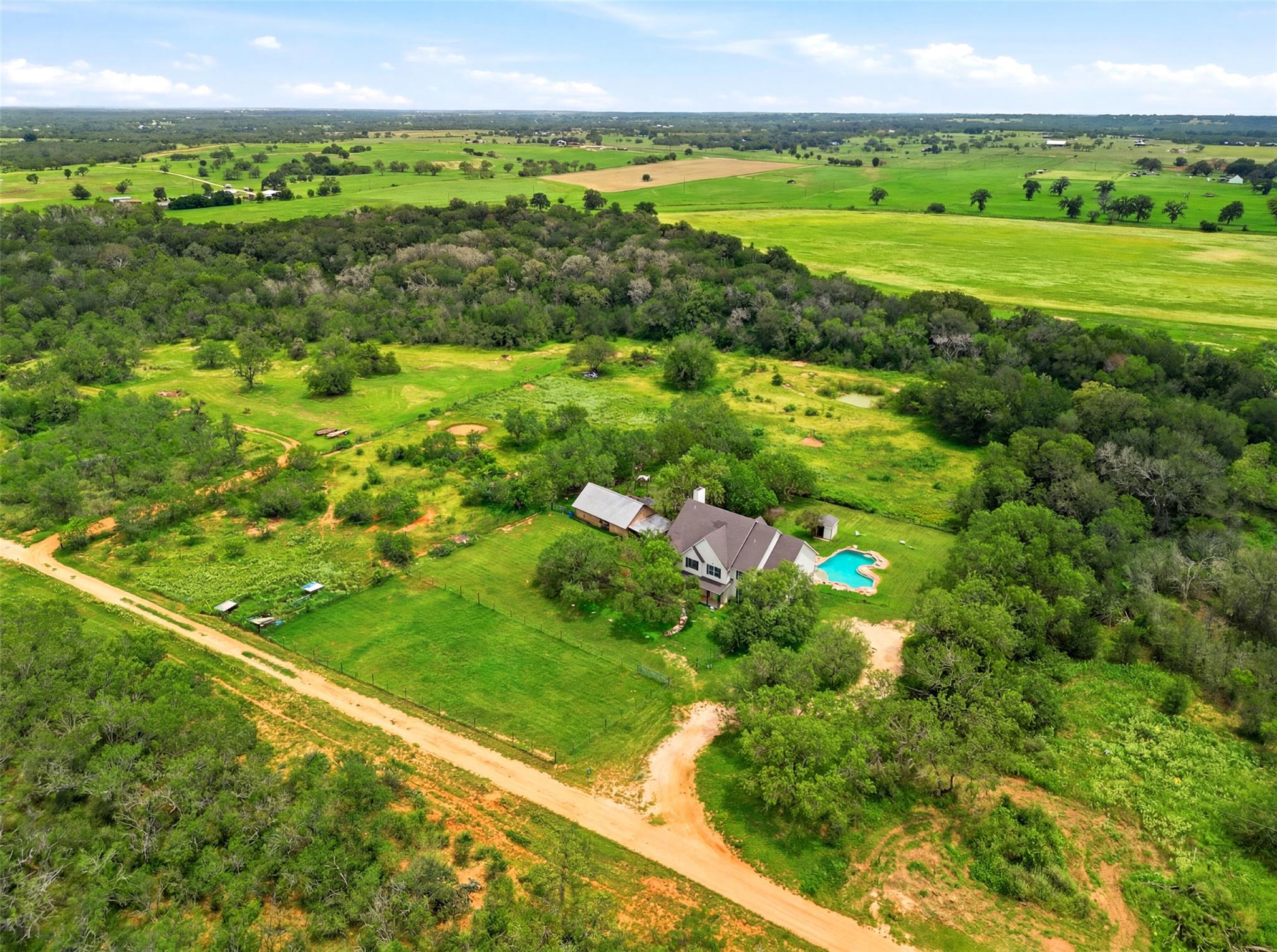 An aerial panorama showcases a secluded residence