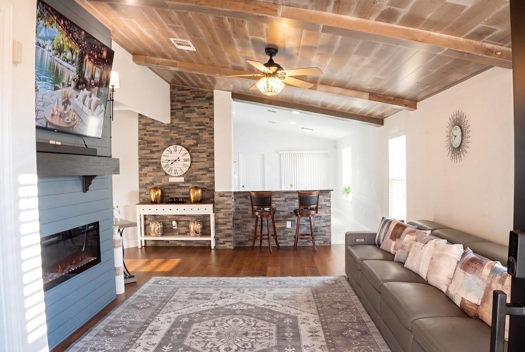 Hardwood floors and a textured accent wall define