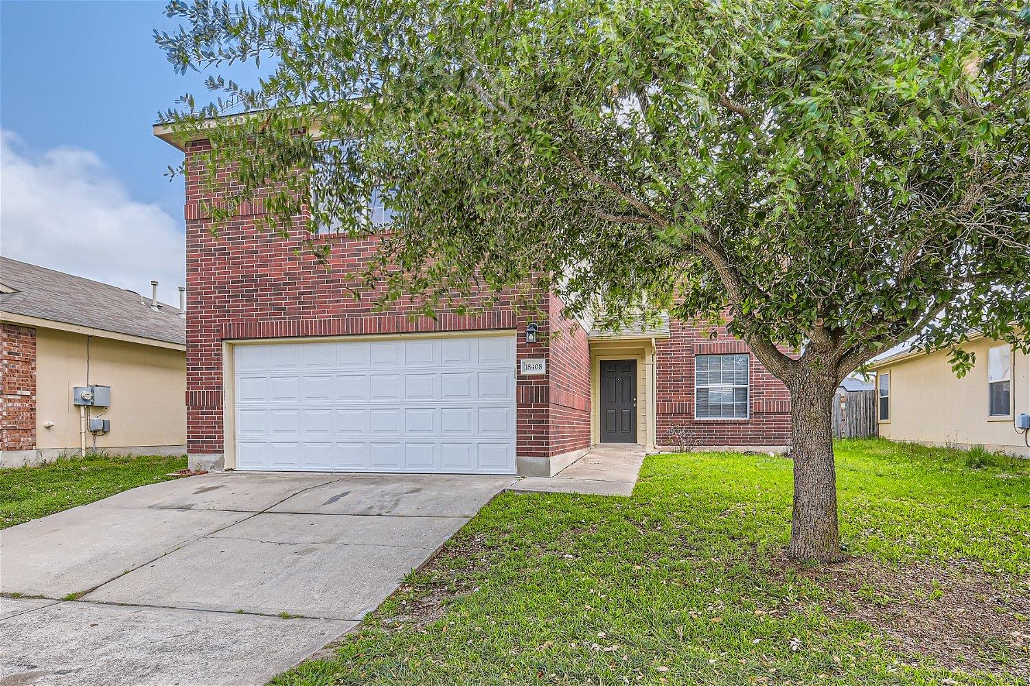 A classic brick exterior and attached garage welc