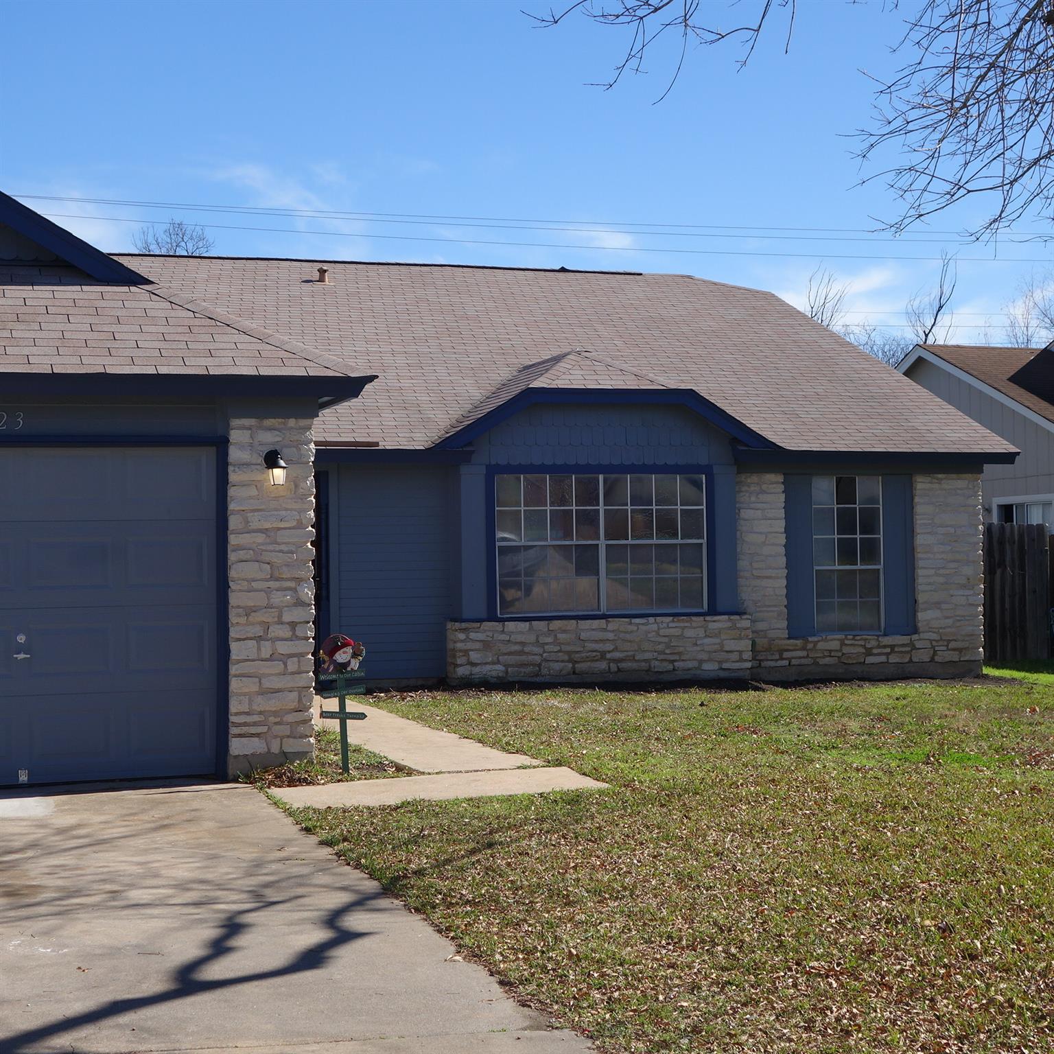 A welcoming stone and siding facade offers classi