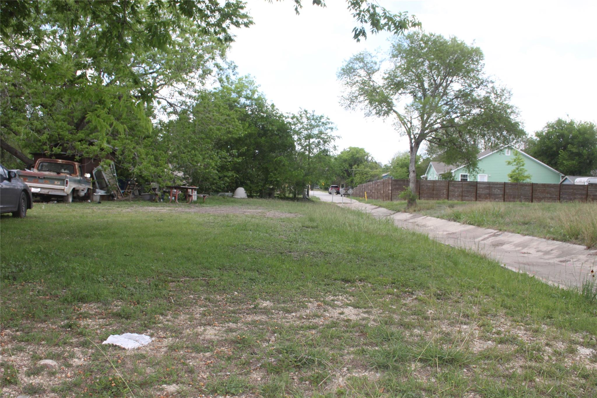 A spacious green lot offers potential for a futur