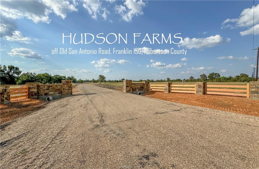 A well-maintained gravel driveway leads to an inv