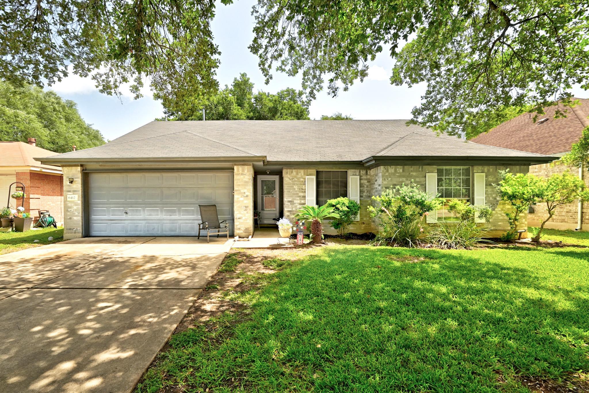 A classic brick exterior and attached garage fram