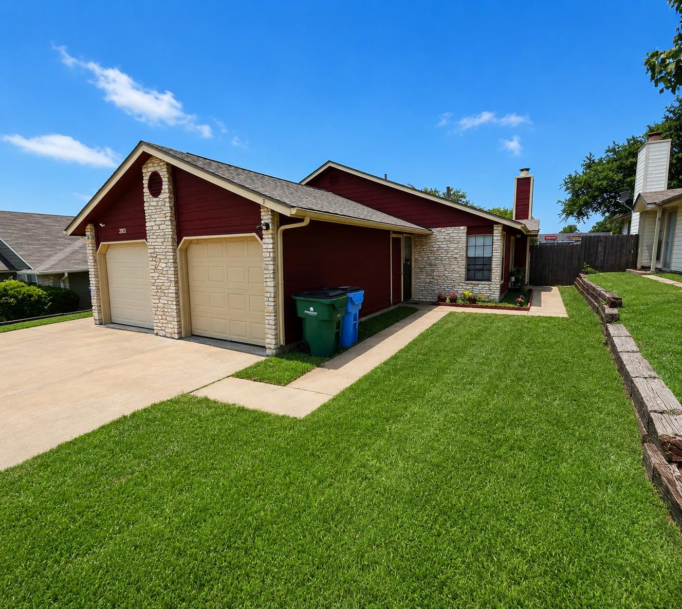 A well-maintained lawn and sturdy stone accents e