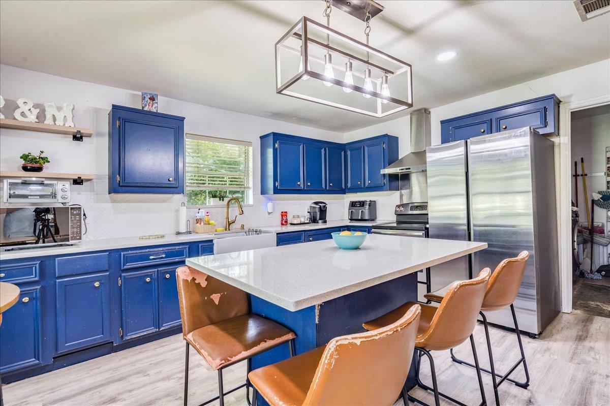 A vibrant kitchen features a bright central islan