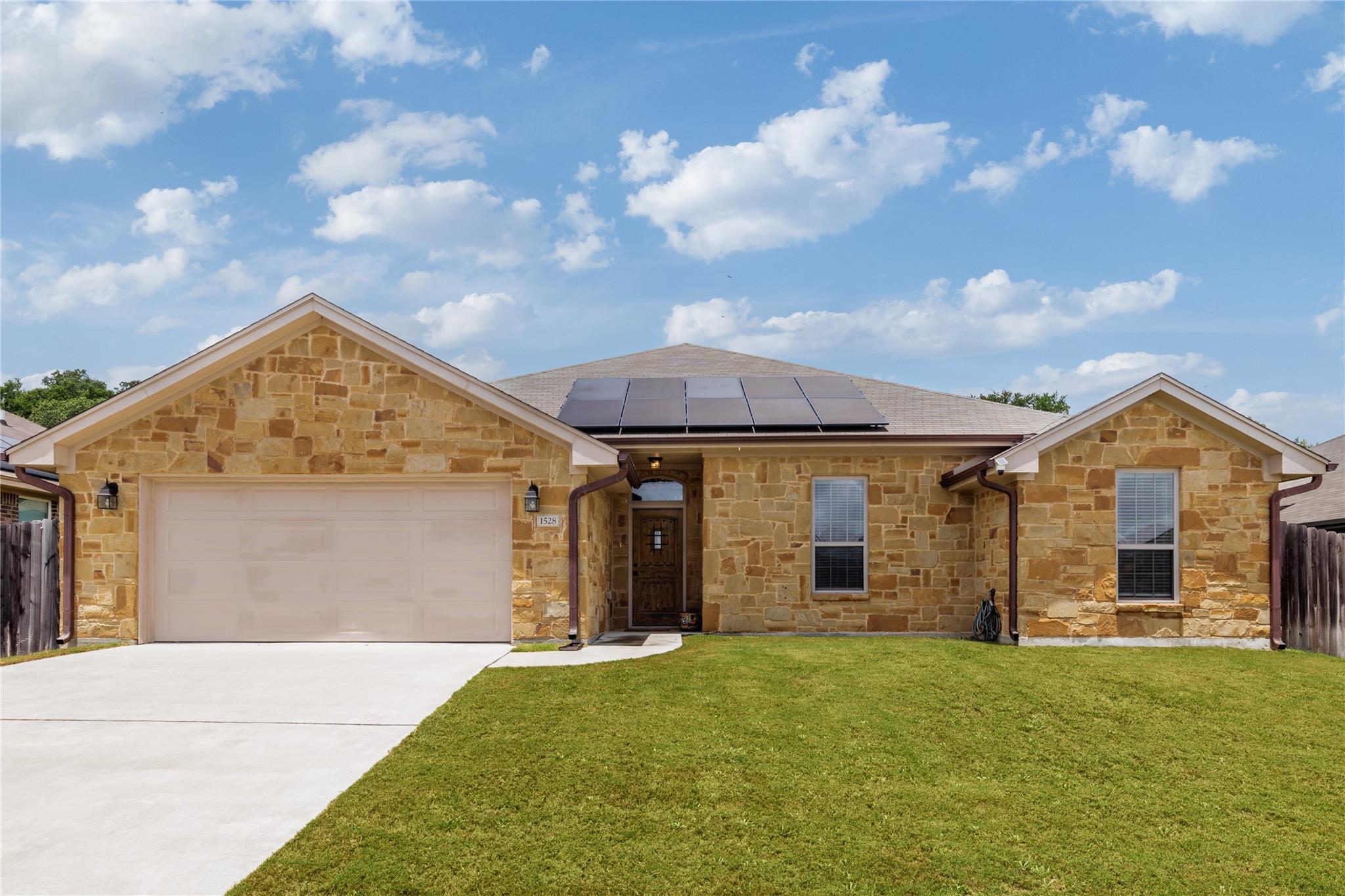 A well-maintained lawn welcomes you to this attra