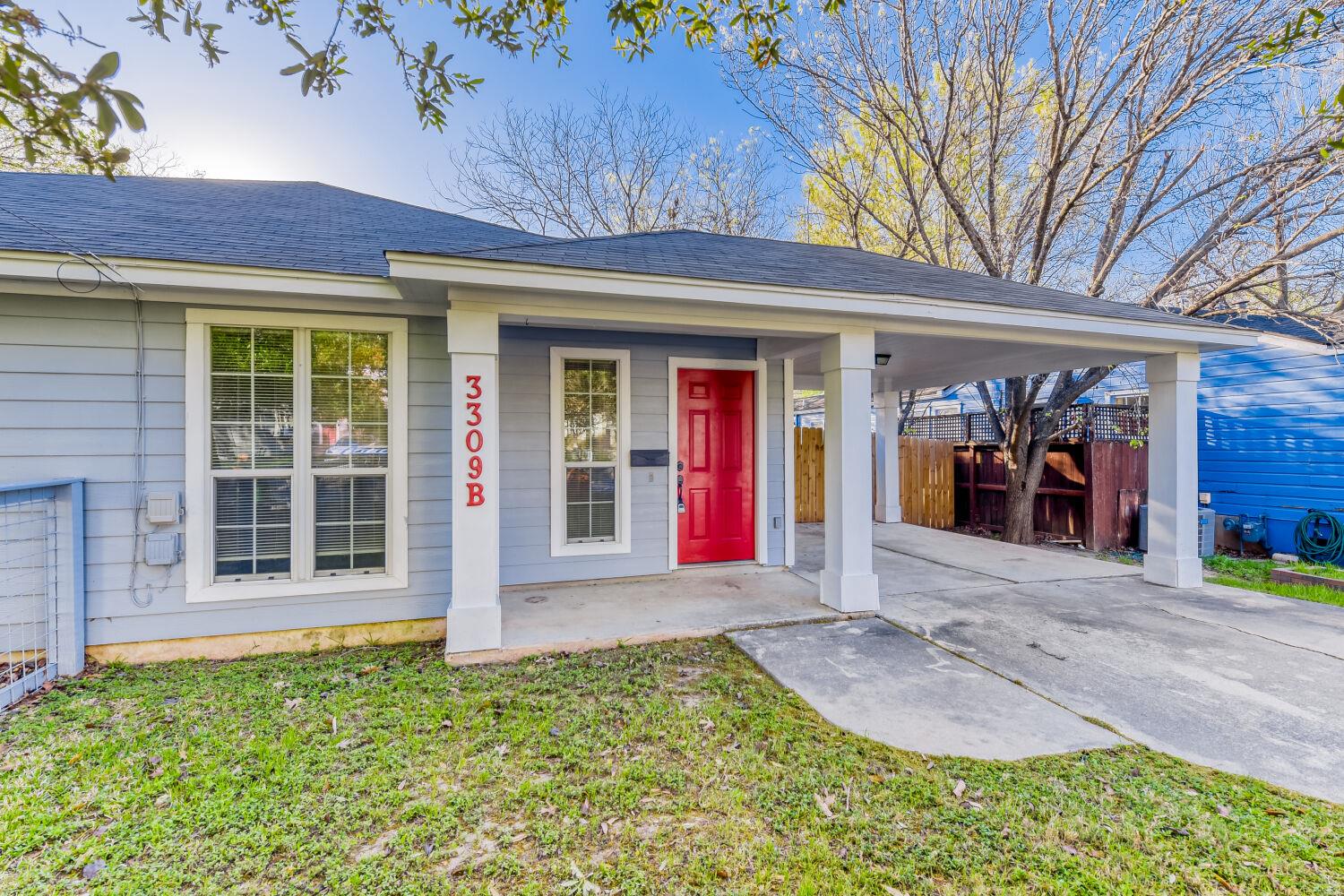 Property entrance featuring a porch, a carport, d