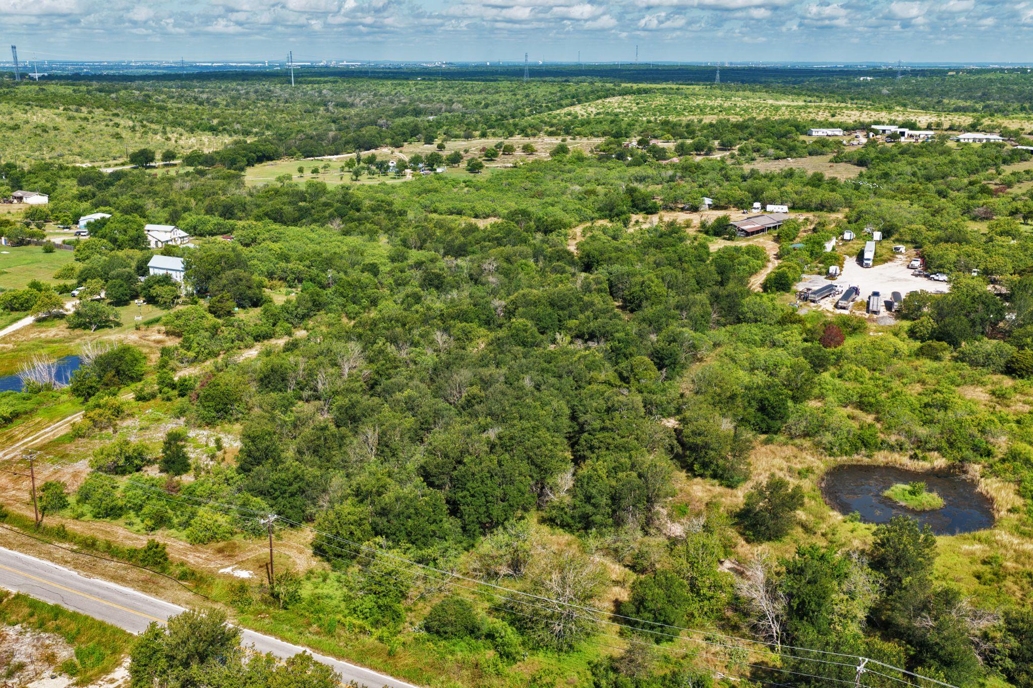 Vast, verdant landscape with scattered buildings,