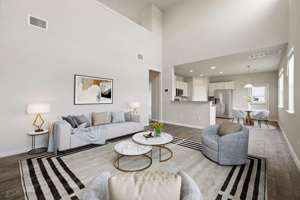 A grand living area showcases soaring ceilings, o