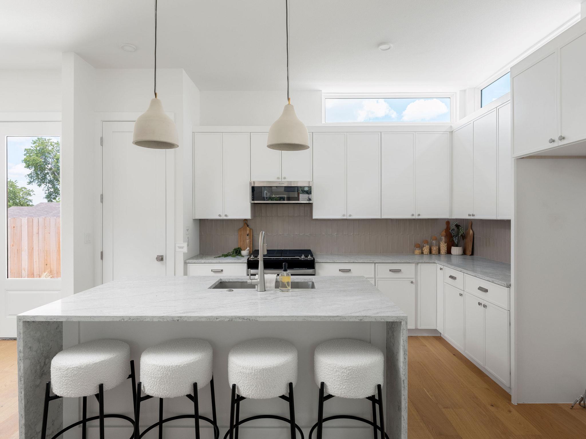 White cabinetry and natural wood floors complete 