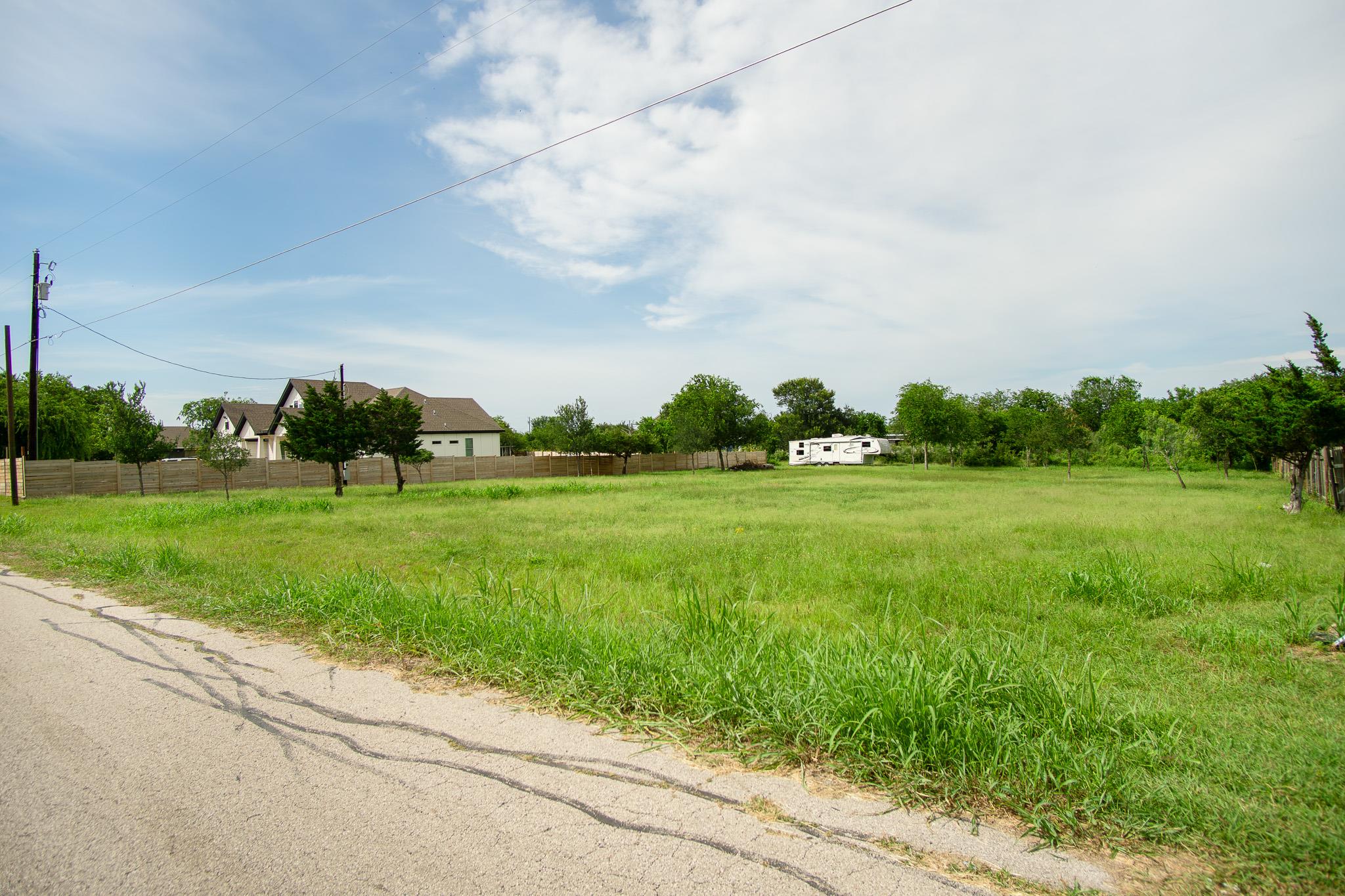 A spacious, verdant lot awaits your vision, borde