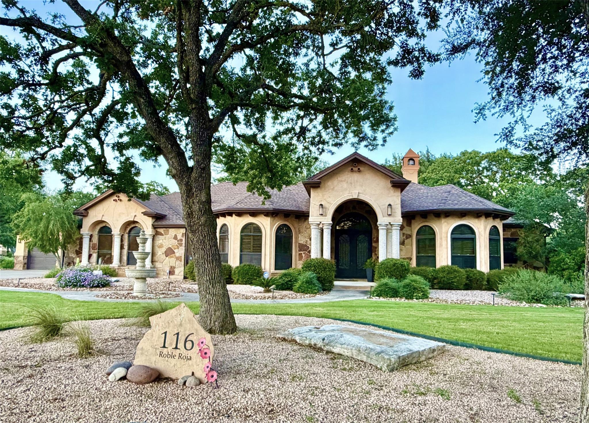 A grand entrance with arched details and stone ac