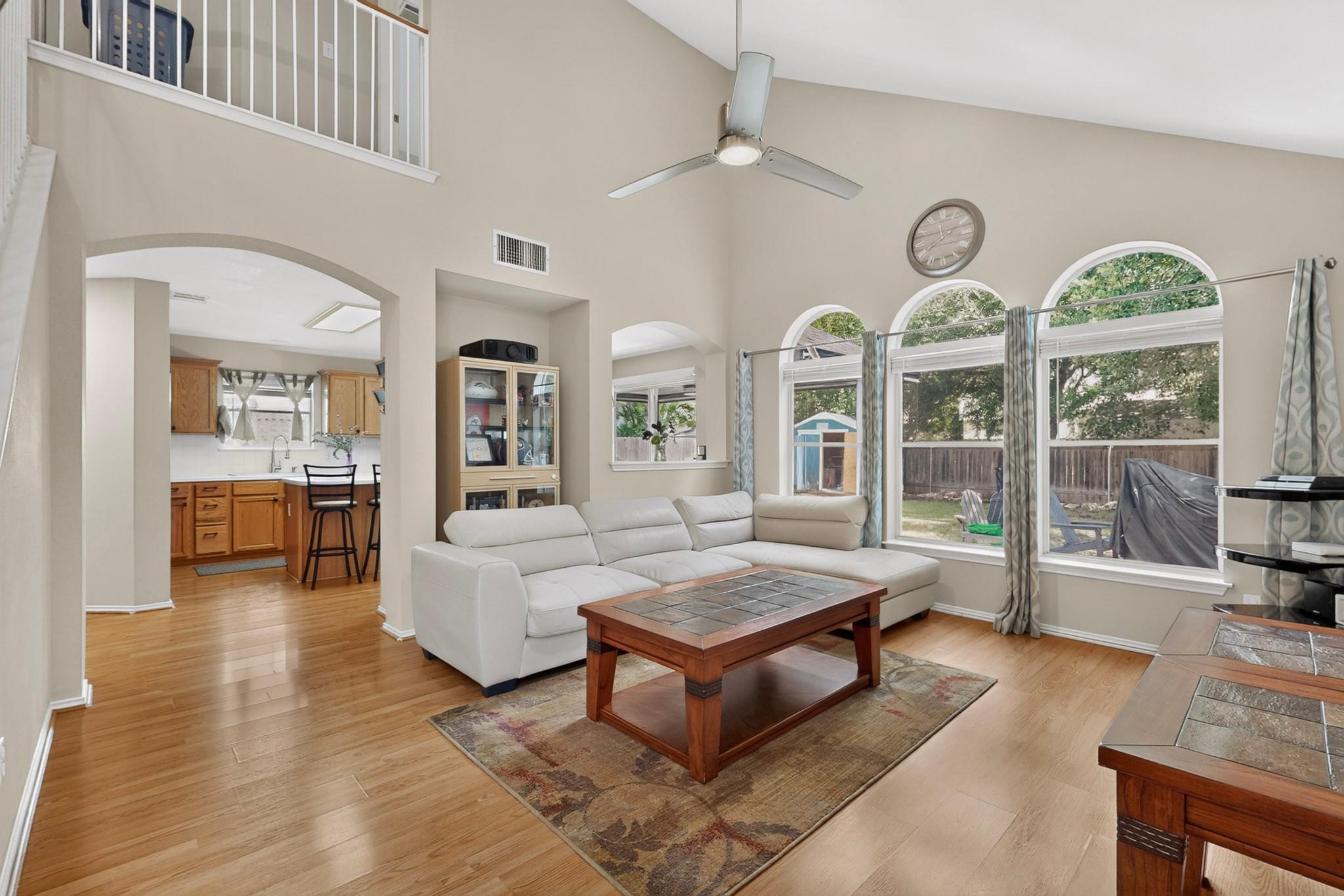 A spacious living area features high vaulted ceil