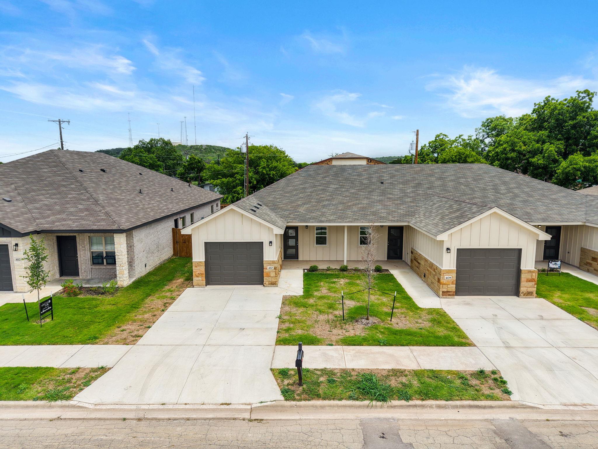 A striking dual residence features individual gar