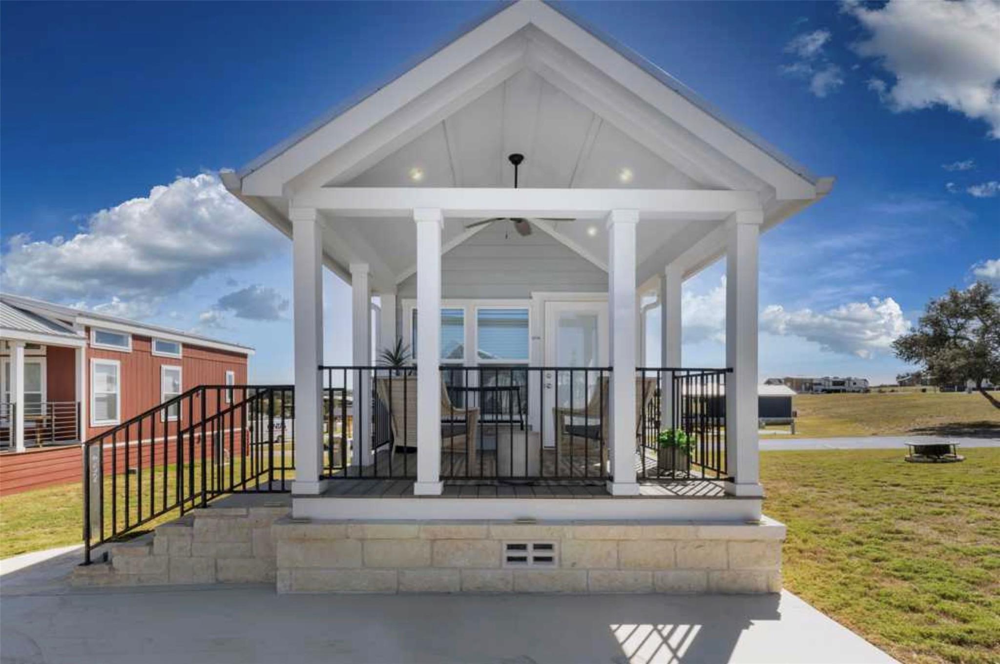 A charming covered porch with white columns invit
