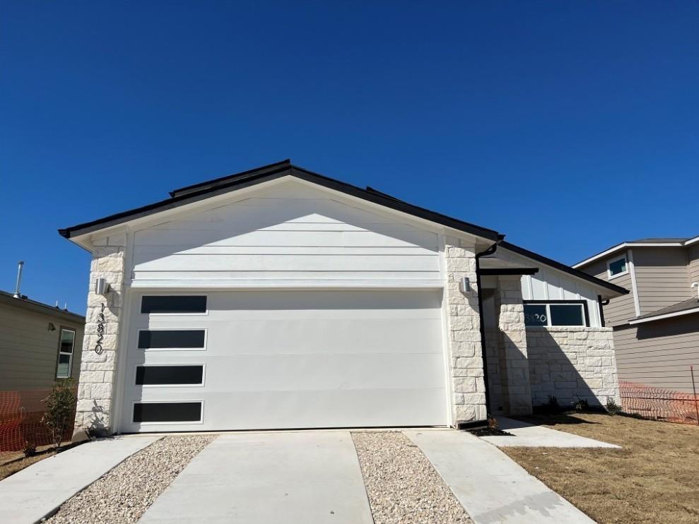 A contemporary façade features a spacious garage 
