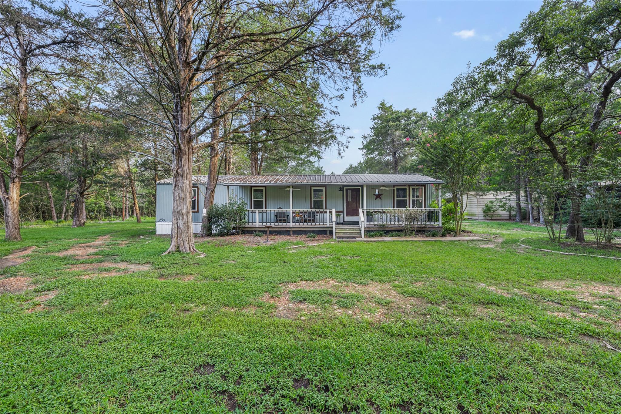 A welcoming front porch extends across this charm