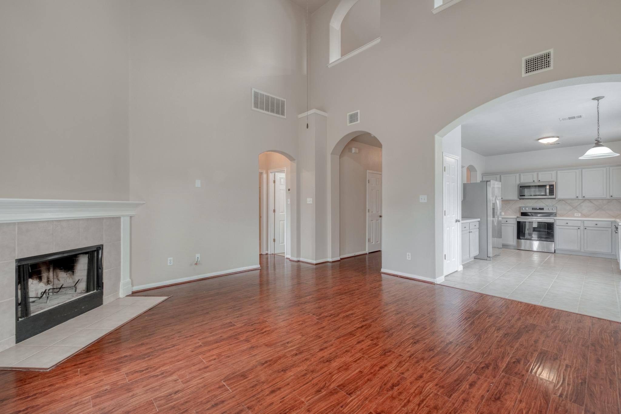 A spacious living area with soaring ceilings tran