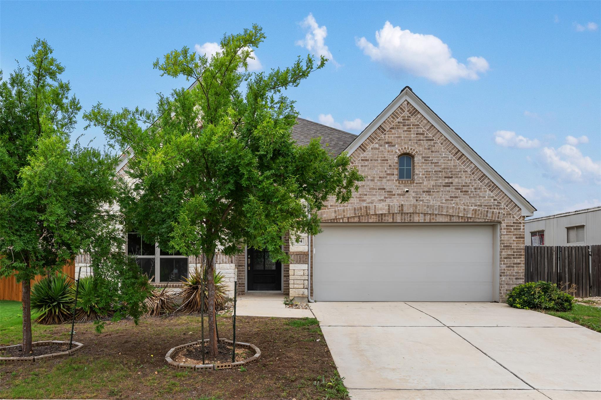 A classic brick and stone facade welcomes with a 