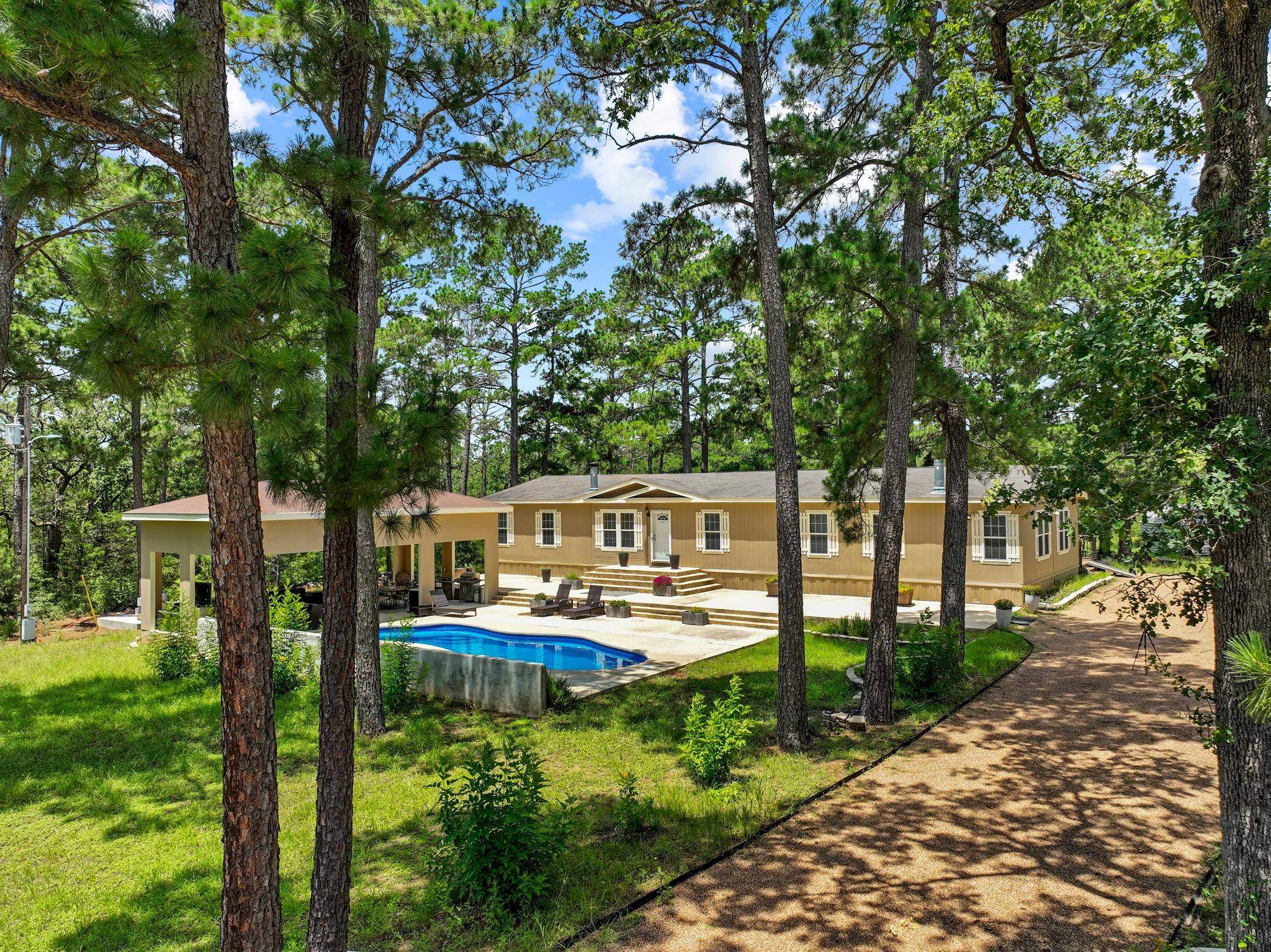 A secluded sylvan retreat features a shimmering p