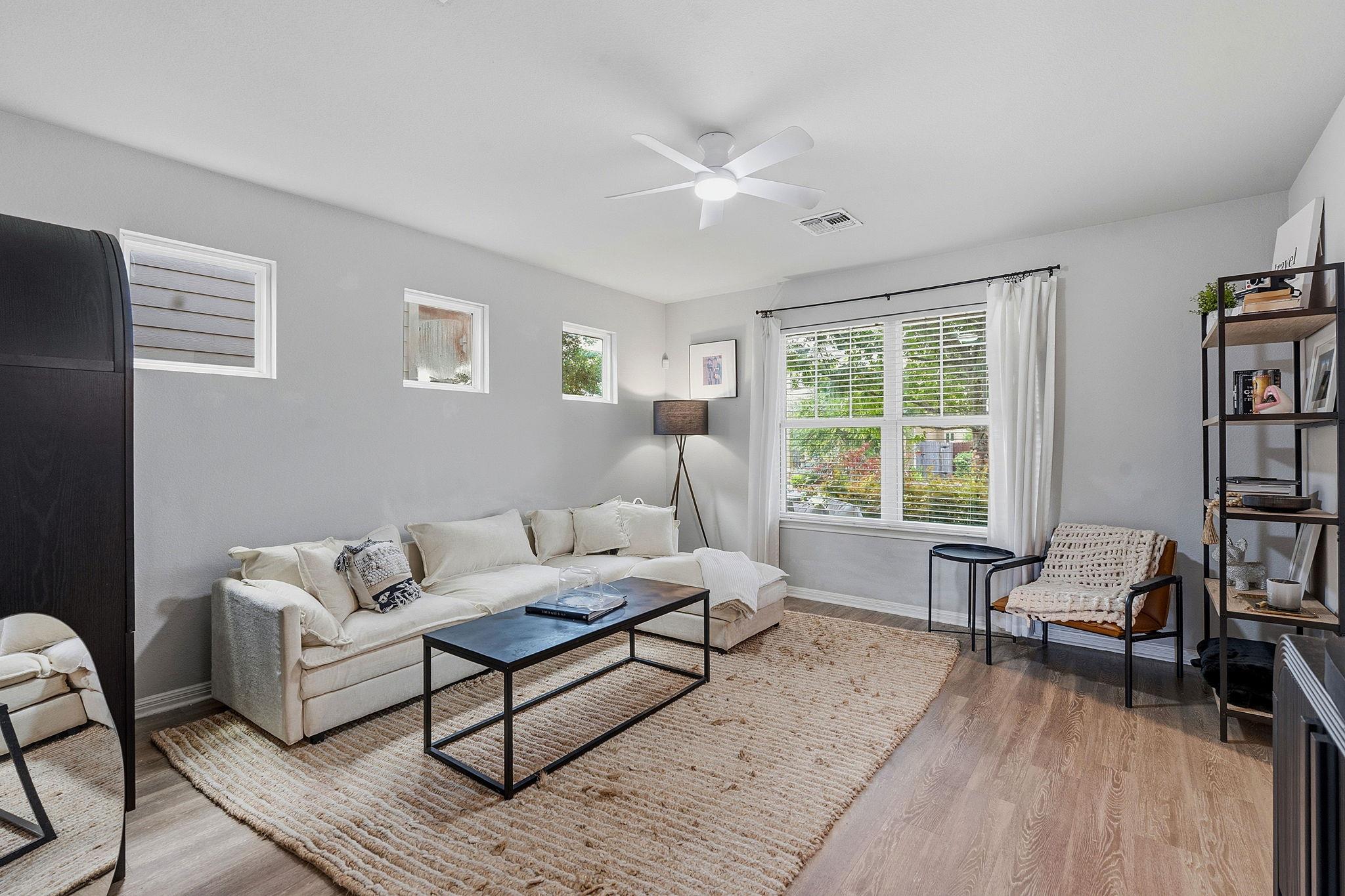 A comfortable living area features light wood flo