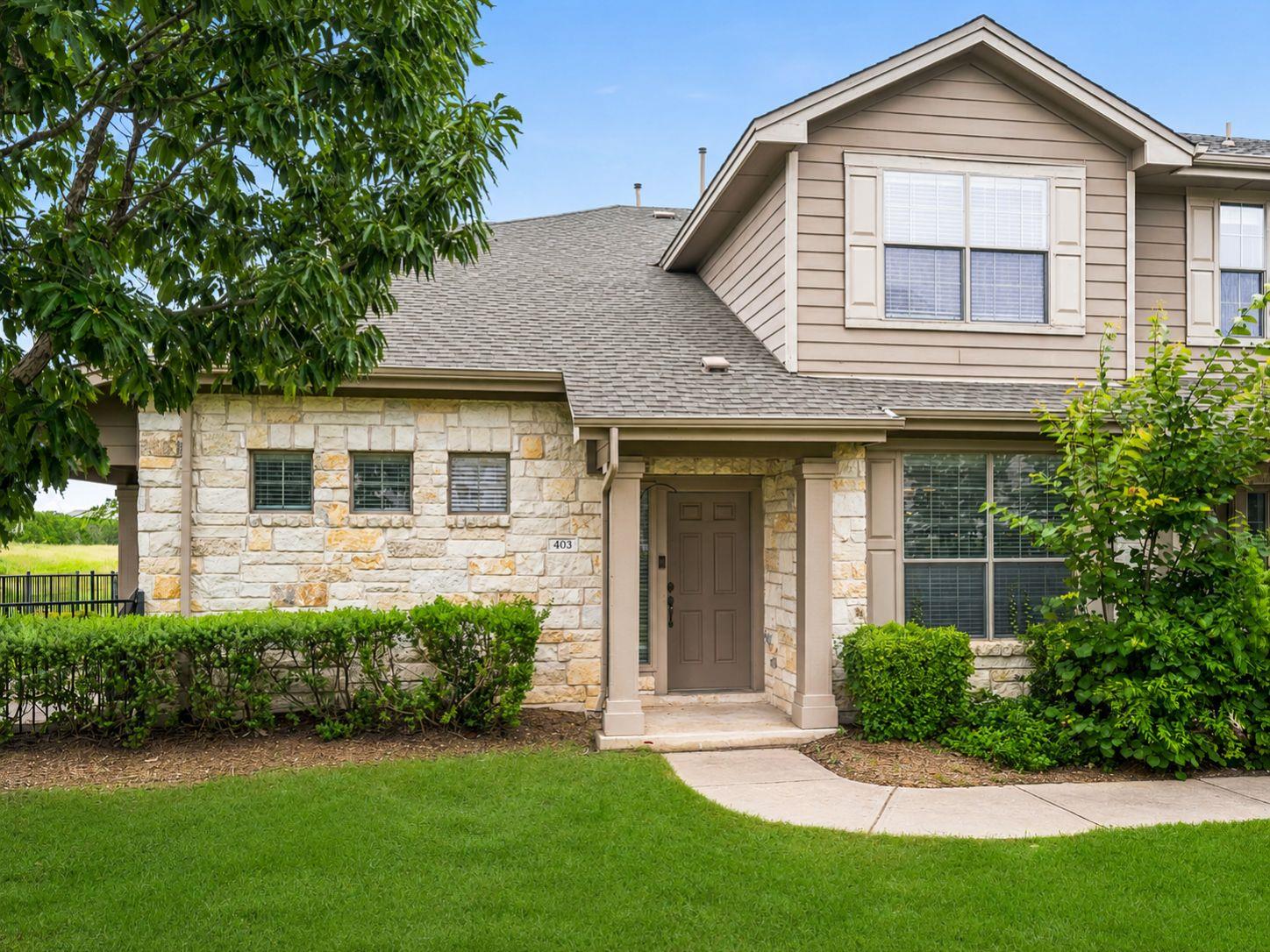 A welcoming stone and siding facade offers excell