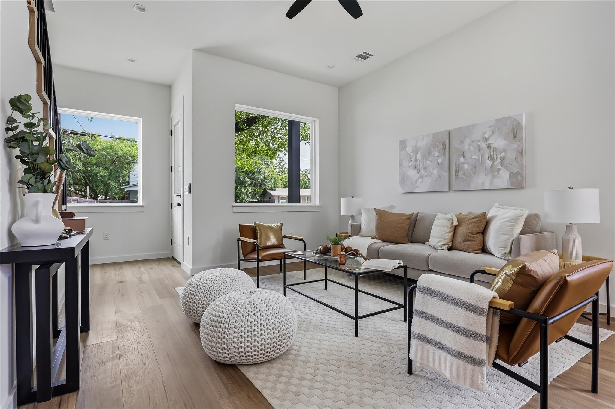 Hardwood floors and generous windows create a lig
