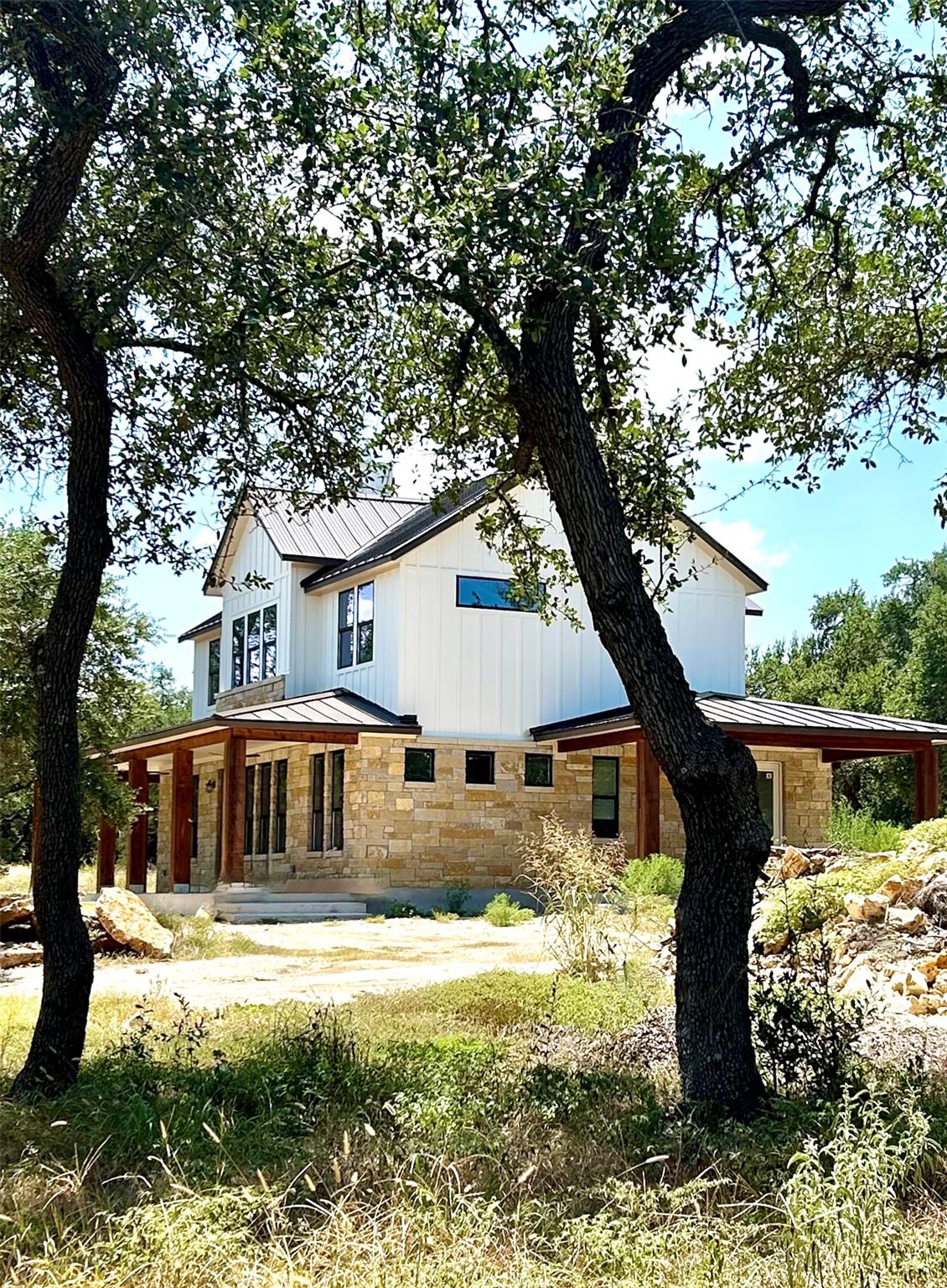 A striking modern farmhouse nestled in a natural 