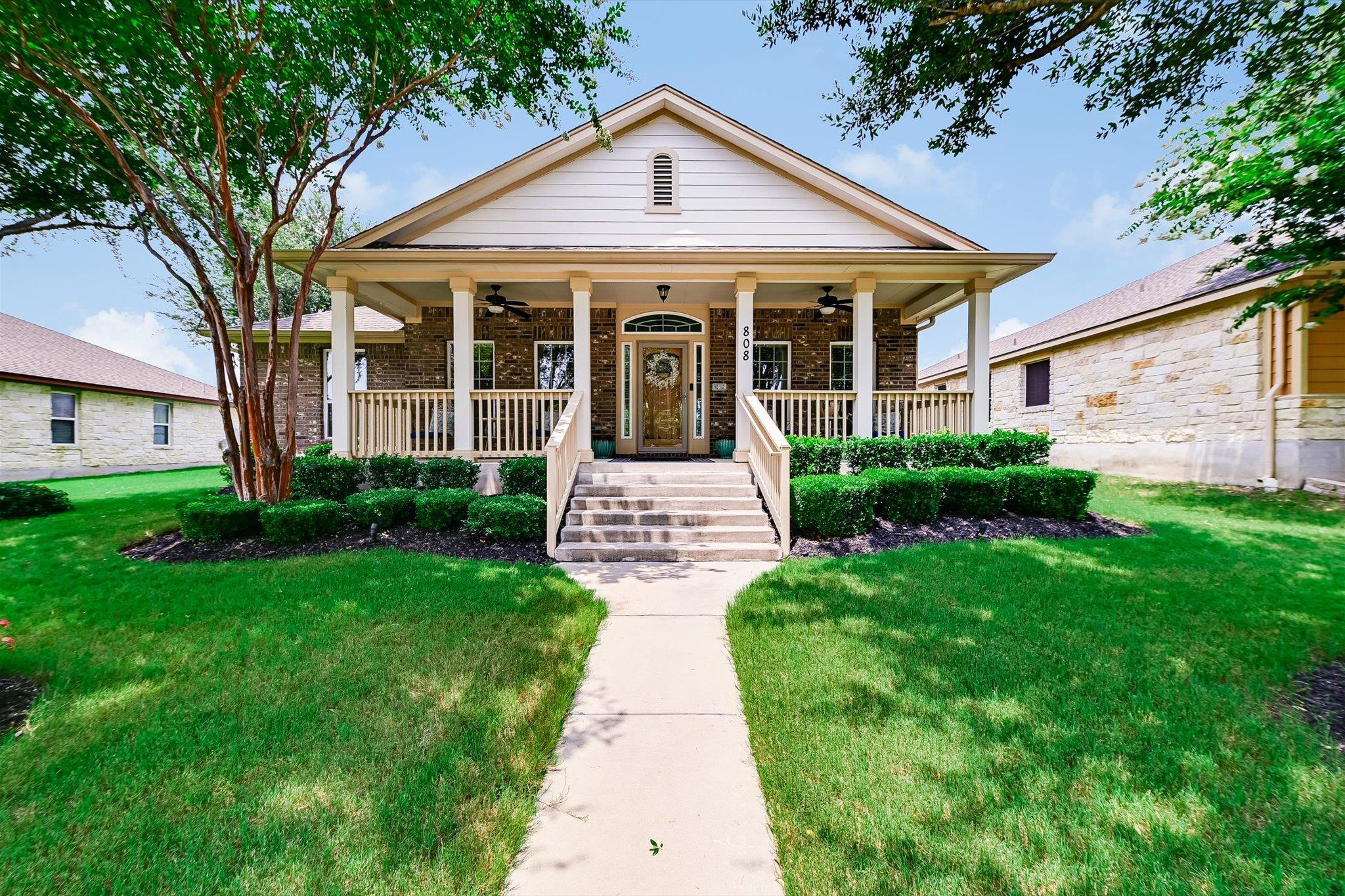 A welcoming brick and siding home presents a broa