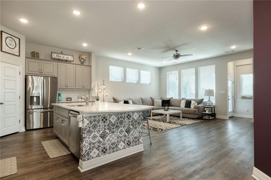 Kitchen featuring gray cabinets, stainless steel 