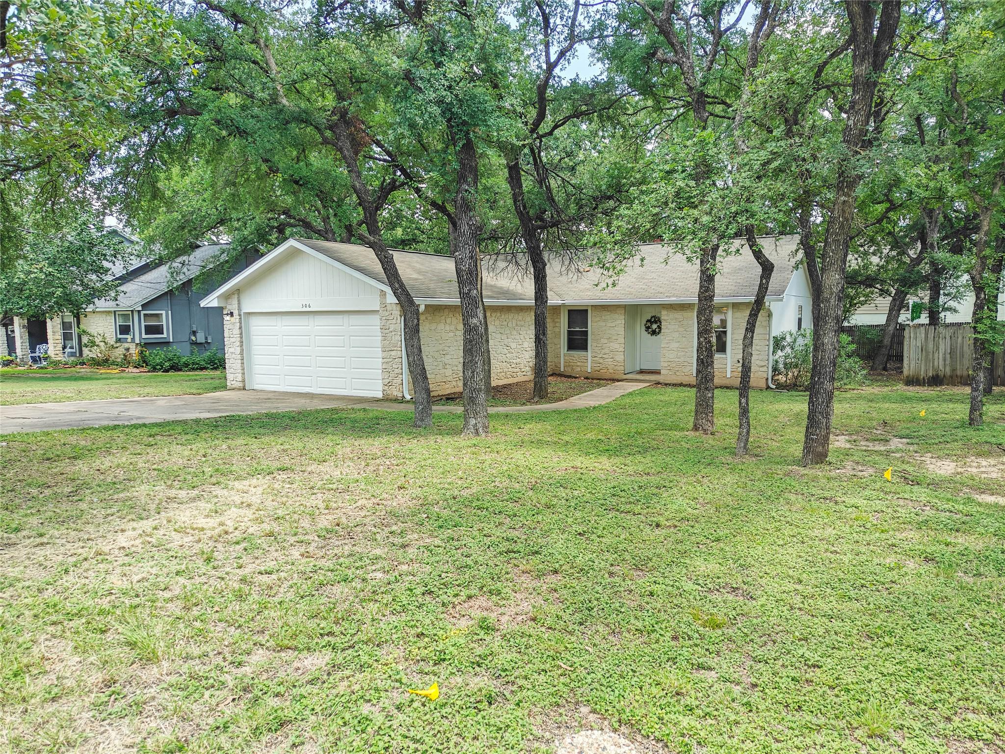 Mature trees shade this single-story home with an