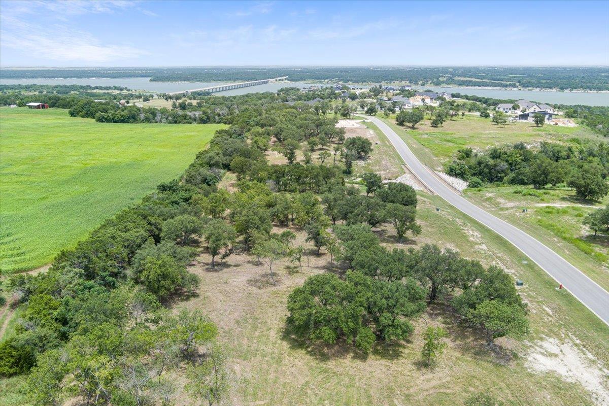 A sprawling lot bordered by a lush green field, w