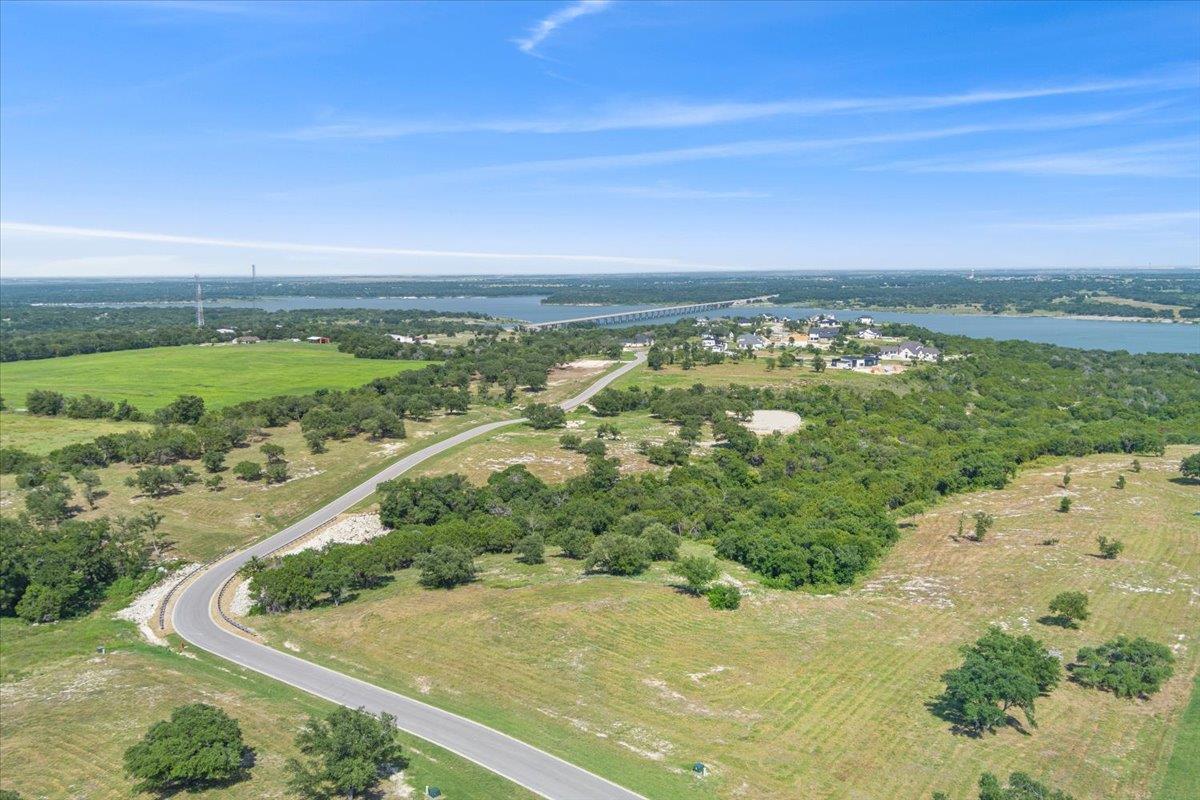 A winding road navigates a verdant landscape, off