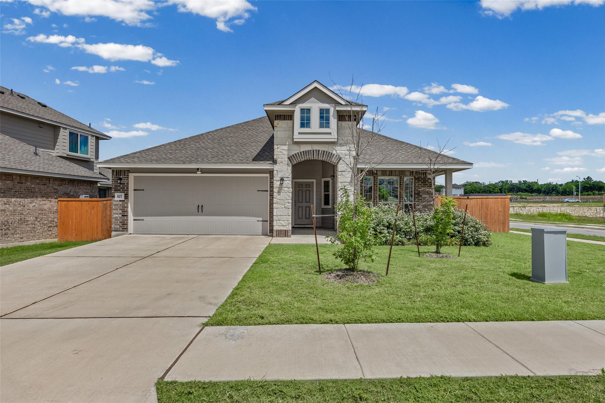 A charming single-story residence with a two-car 