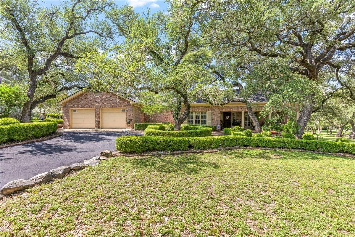 Mature trees and meticulously manicured hedges fr