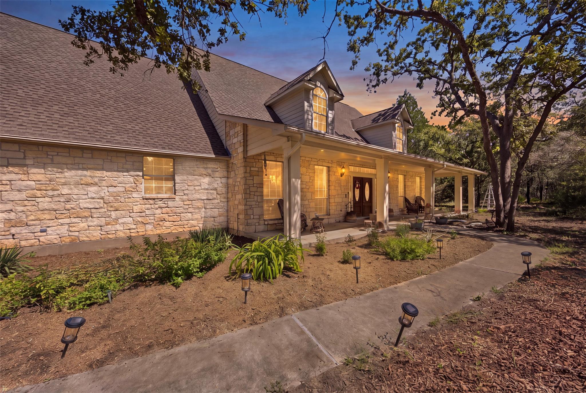 A long, covered porch with stone detailing offers