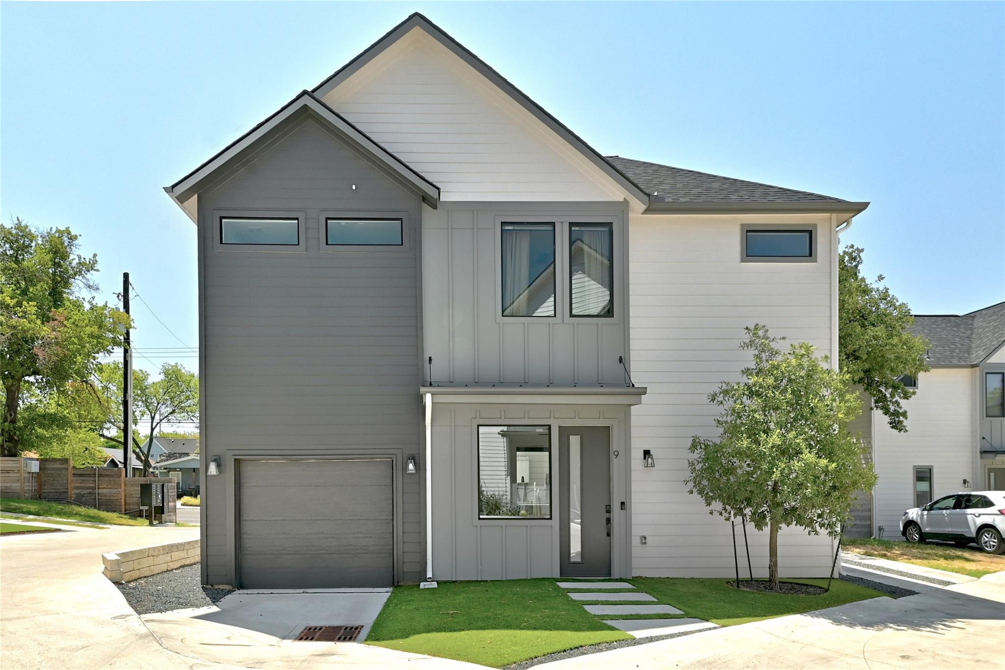 Modern facade with a blend of siding and large wi