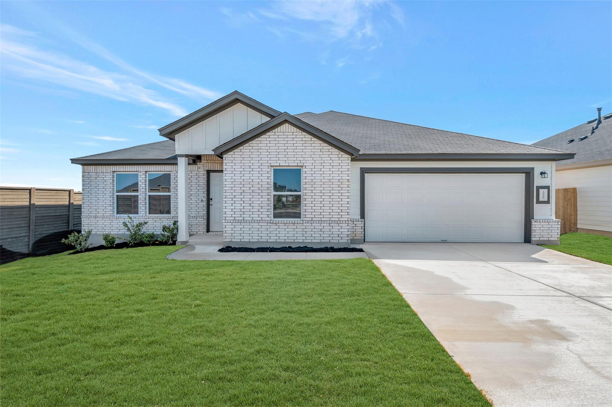 A neatly maintained lawn fronts this inviting sin