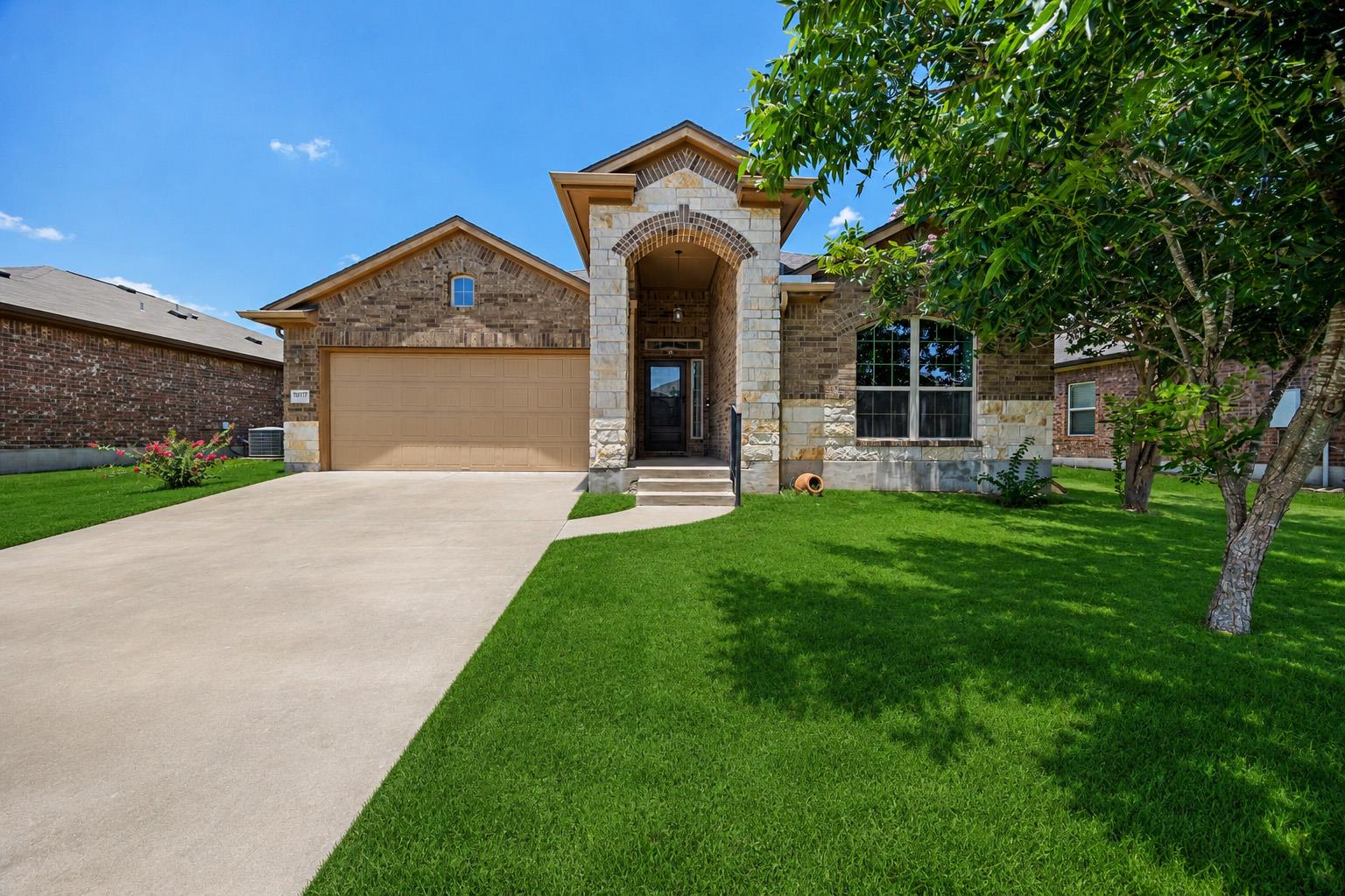 A classic brick and stone facade welcomes with an