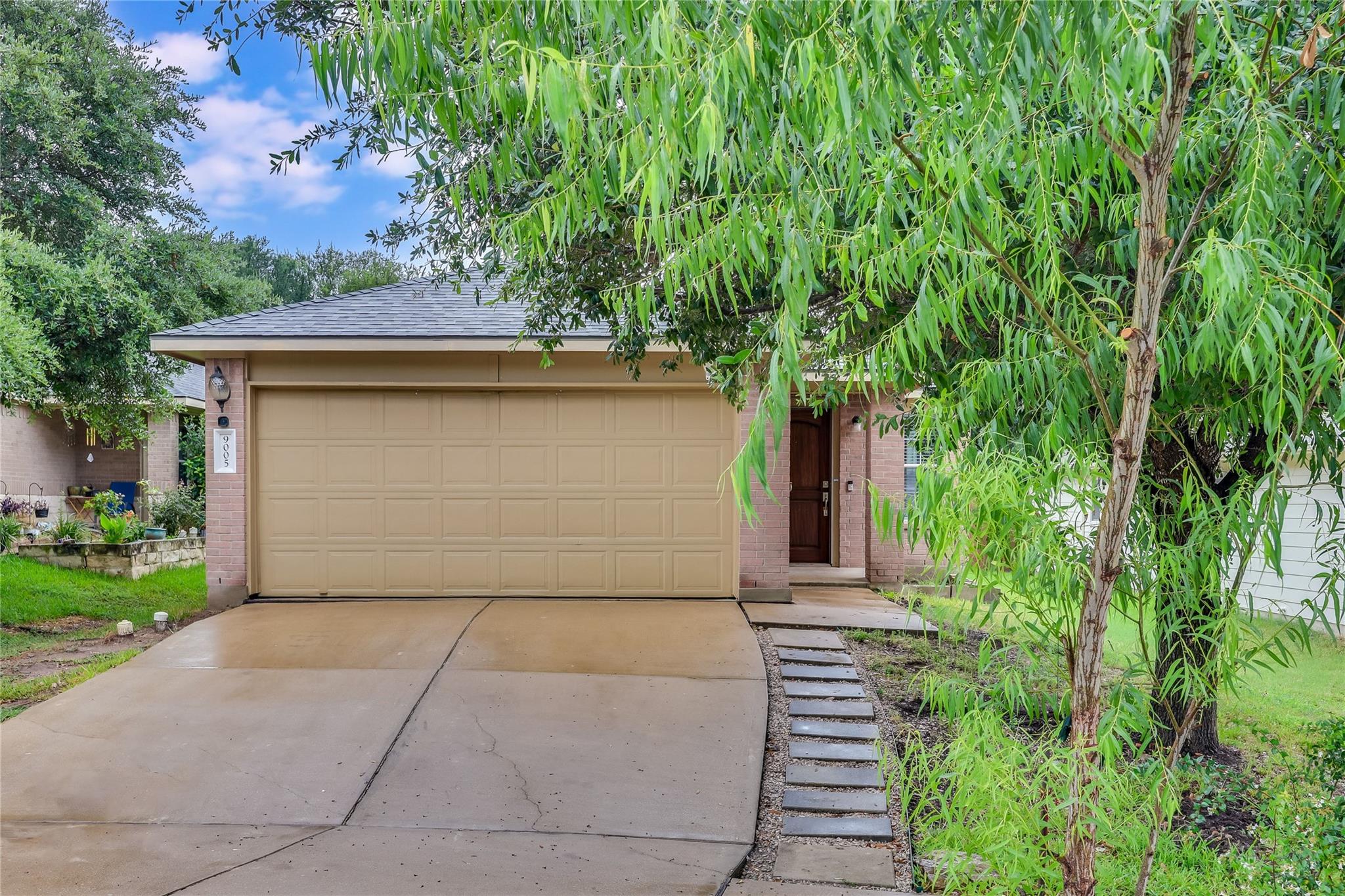A well-maintained facade features a garage, invit